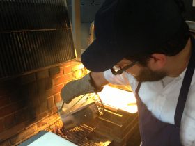 Suarez pours sizzlin' coals on the grill (Photo: Natalie Rinn) 