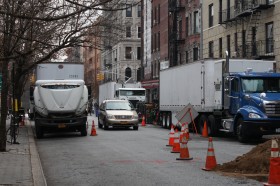 Film crews pack up as construction workers dig on a sewer line next door. (photo by Patrick Hogan)